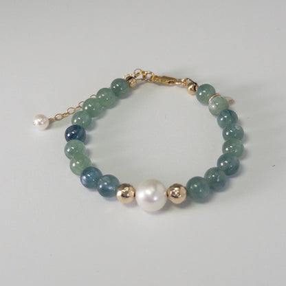 Bicolor kyanite, pearl and initial gold bracelet featuring naturally zoned blue-green gemstone beads, lustrous freshwater pearls and a personalised gold-filled stamped initial disc.