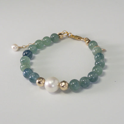 Bicolor kyanite, pearl and initial gold bracelet featuring naturally zoned blue-green gemstone beads, lustrous freshwater pearls and a personalised gold-filled stamped initial disc.