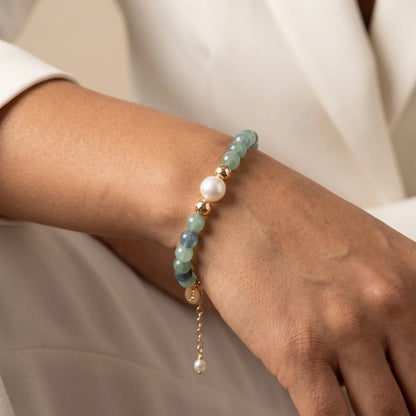 Bicolor kyanite, pearl and initial gold bracelet featuring naturally zoned blue-green gemstone beads, lustrous freshwater pearls and a personalised gold-filled stamped initial disc.