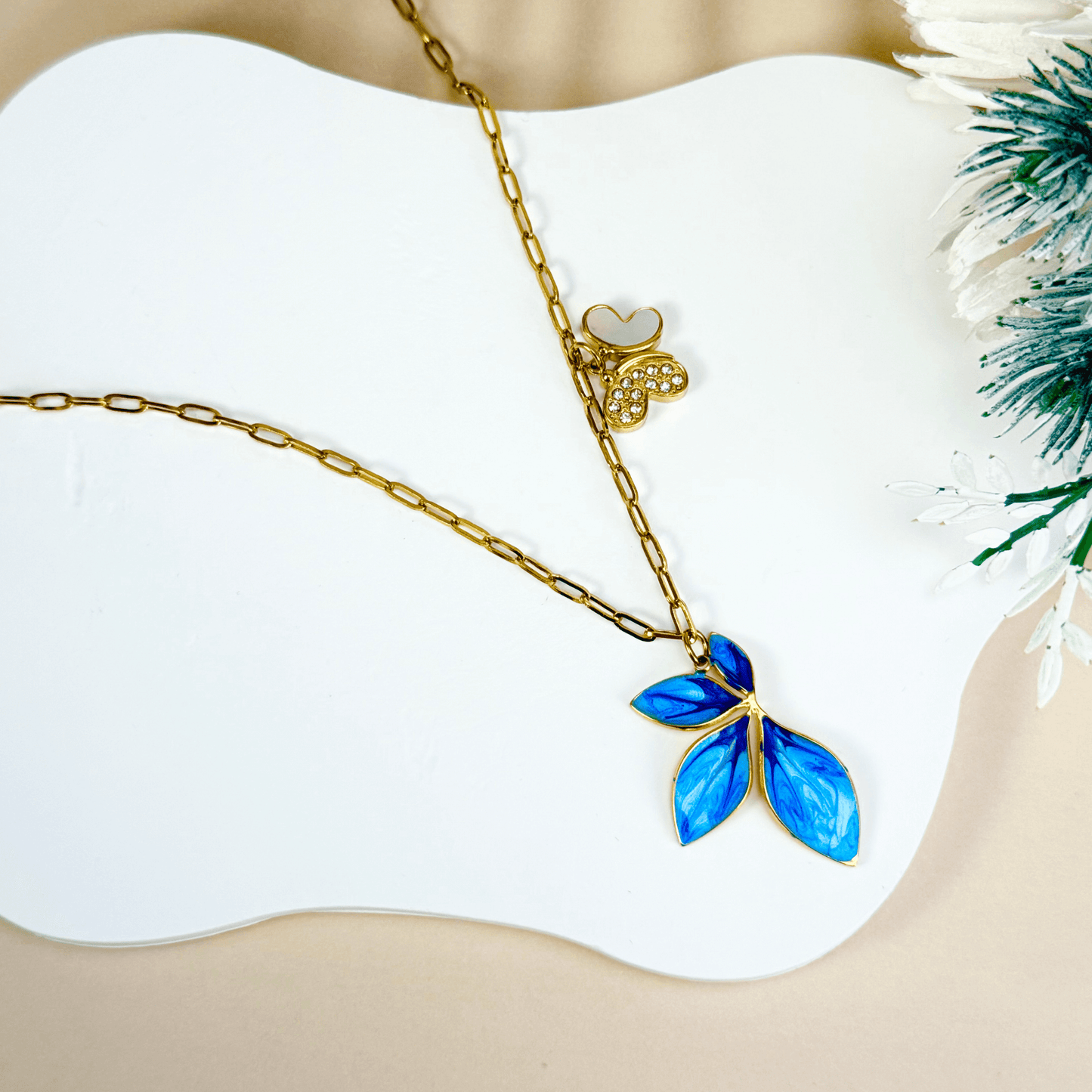 Gold charm necklace with blue enamel leaf, butterfly on waterproof paperclip chain