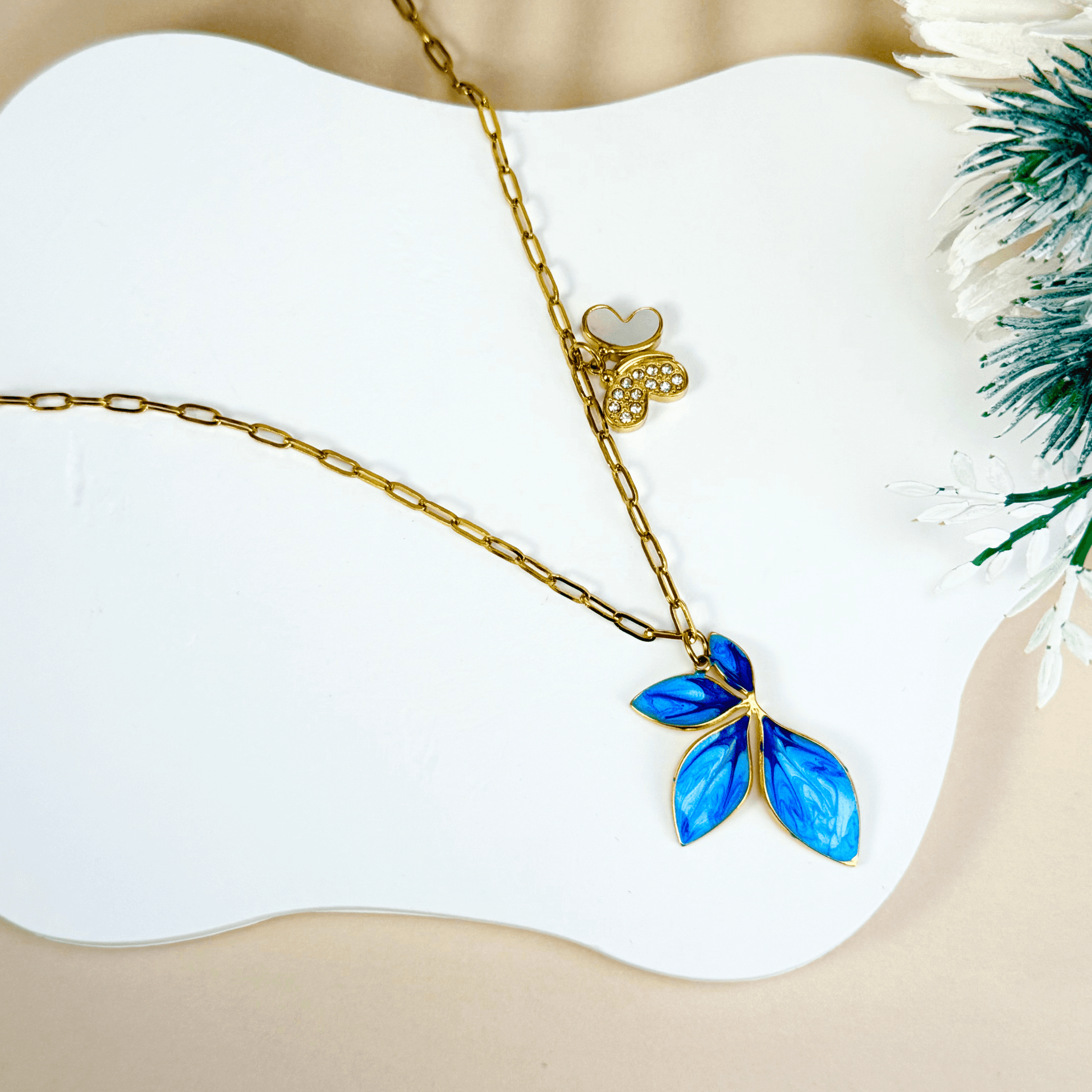 Gold charm necklace with blue enamel leaf, butterfly on waterproof paperclip chain