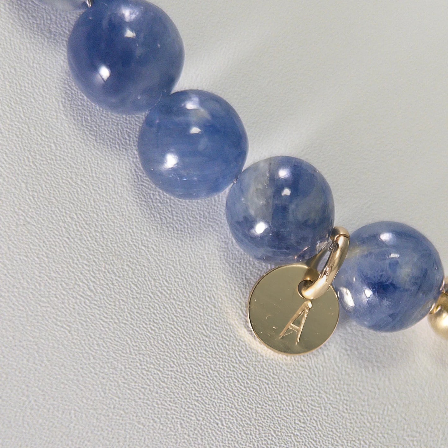 Blue kyanite, pearl and initial gold bracelet featuring Brazilian blue kyanite beads, lustrous freshwater pearls and a personalised gold-filled stamped initial disc.
