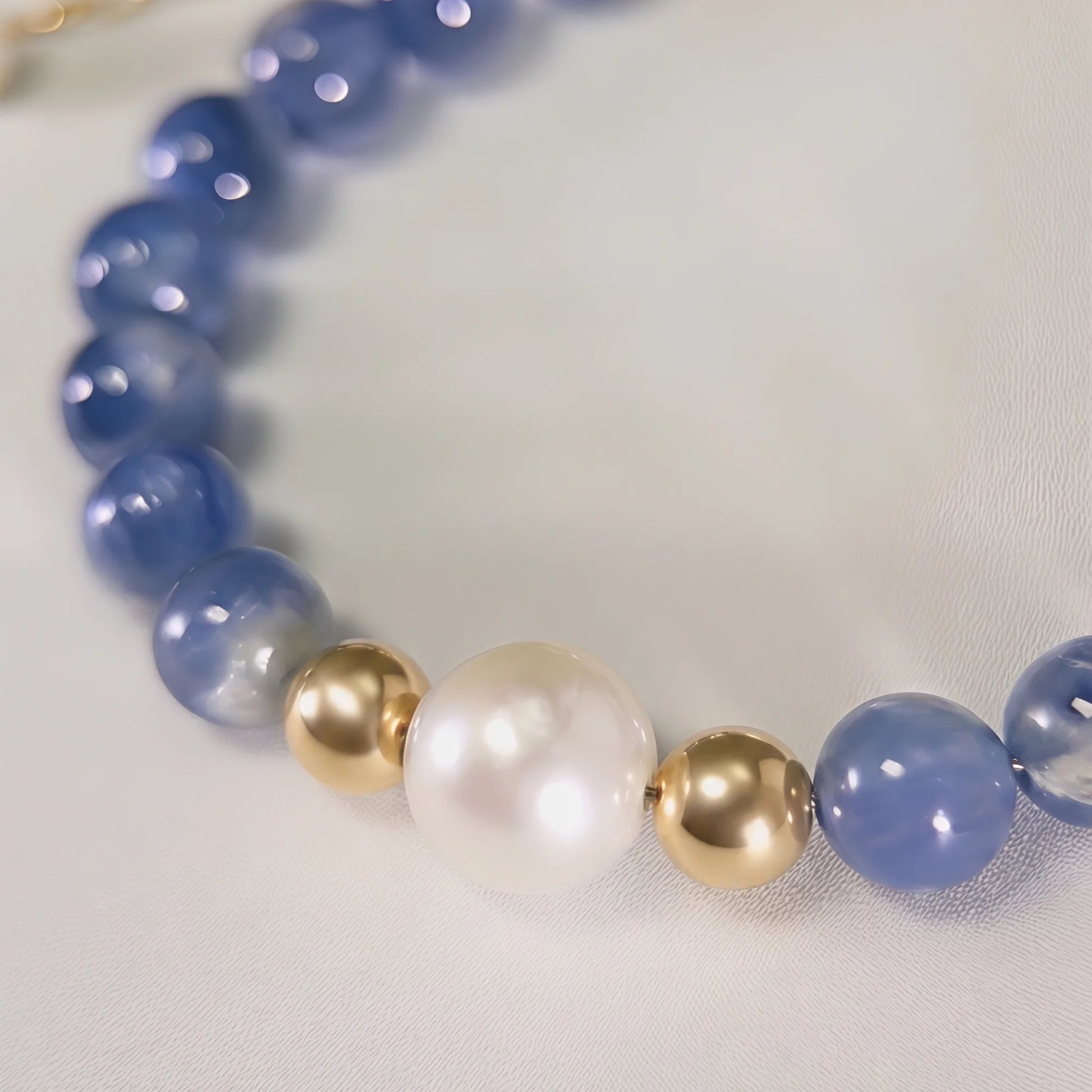 Blue kyanite, pearl and initial gold bracelet featuring Brazilian blue kyanite beads, lustrous freshwater pearls and a personalised gold-filled stamped initial disc.