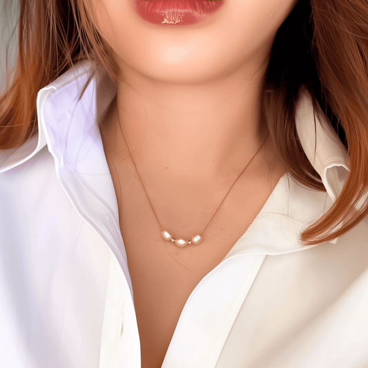 Blush pink freshwater pearl necklace with three pearls on a fine chain, available in gold filled and sterling silver options.