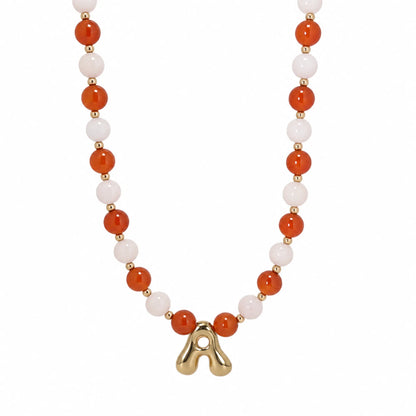 personalised 14K gold filled necklace with alternating carnelian and pink morganite beads, gold spacers and bubble initial letter.