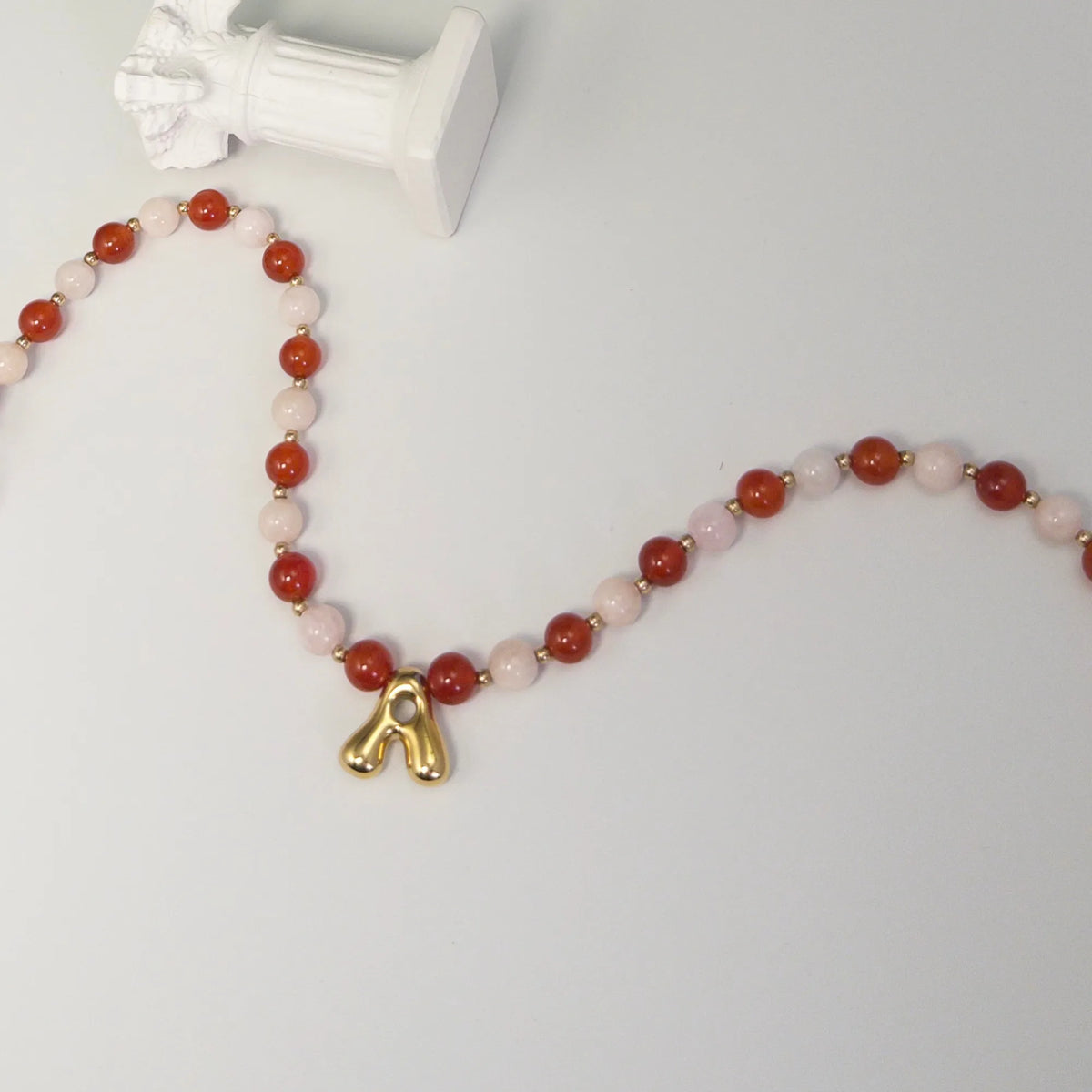 personalised 14K gold filled necklace with alternating carnelian and pink morganite beads, gold spacers and bubble initial letter.
