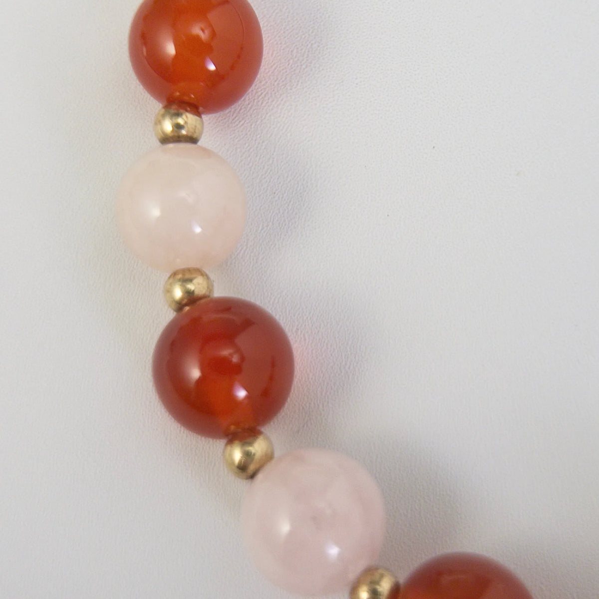 personalised 14K gold filled necklace with alternating carnelian and pink morganite beads, gold spacers and bubble initial letter.