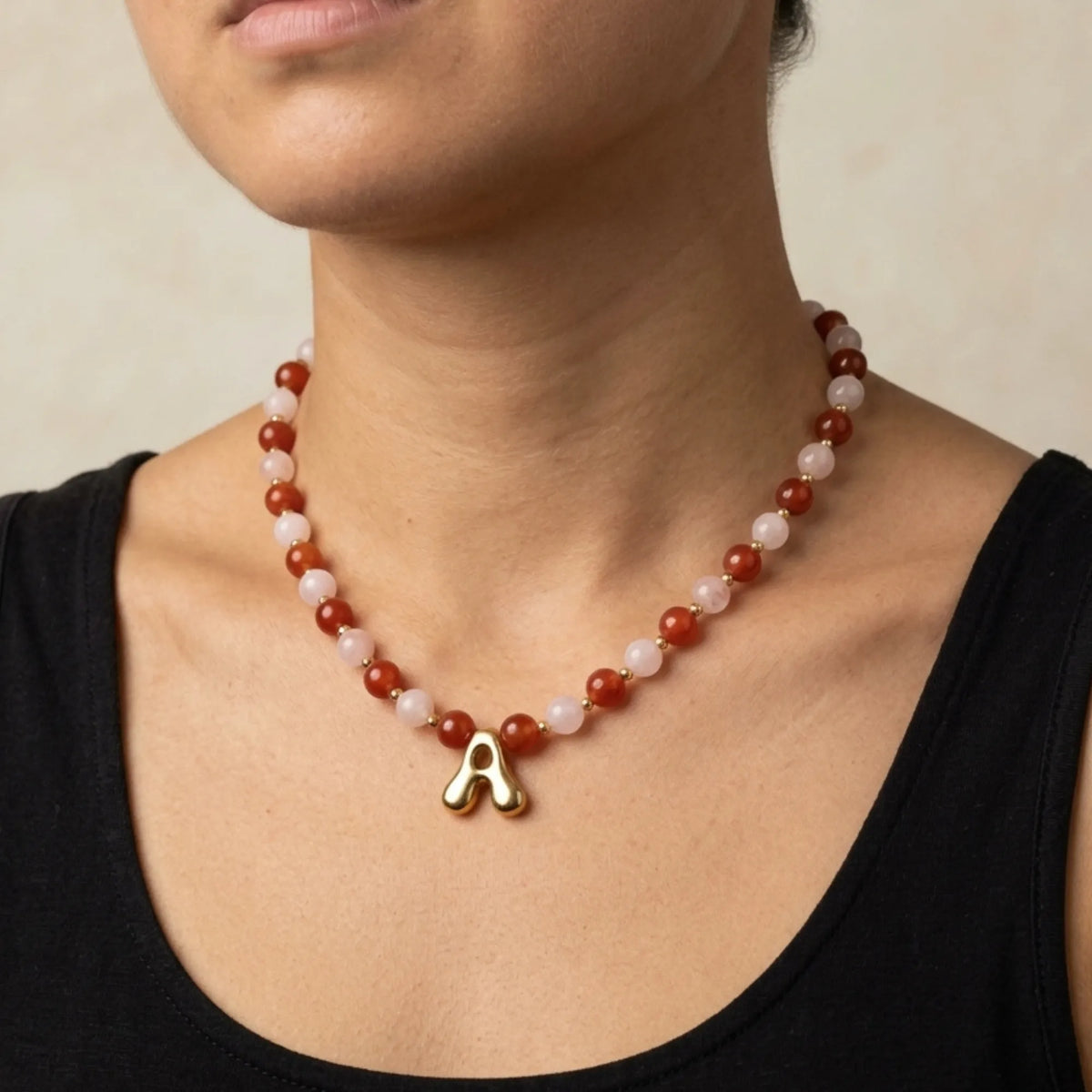 personalised 14K gold filled necklace with alternating carnelian and pink morganite beads, gold spacers and bubble initial letter.