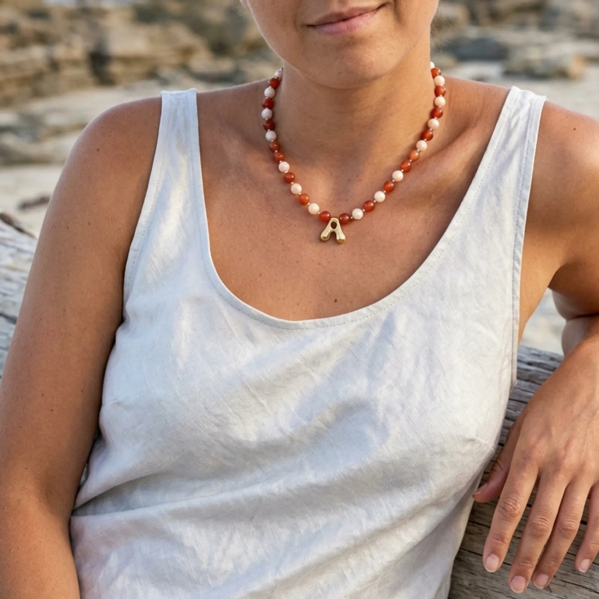 personalised 14K gold filled necklace with alternating carnelian and pink morganite beads, gold spacers and bubble initial letter.