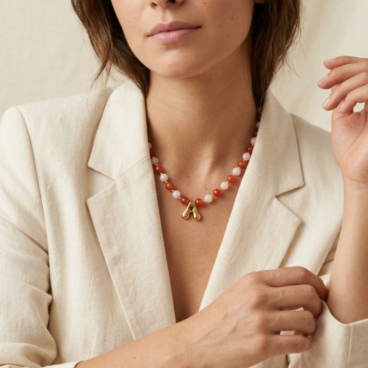 personalised 14K gold filled necklace with alternating carnelian and pink morganite beads, gold spacers and bubble initial letter.