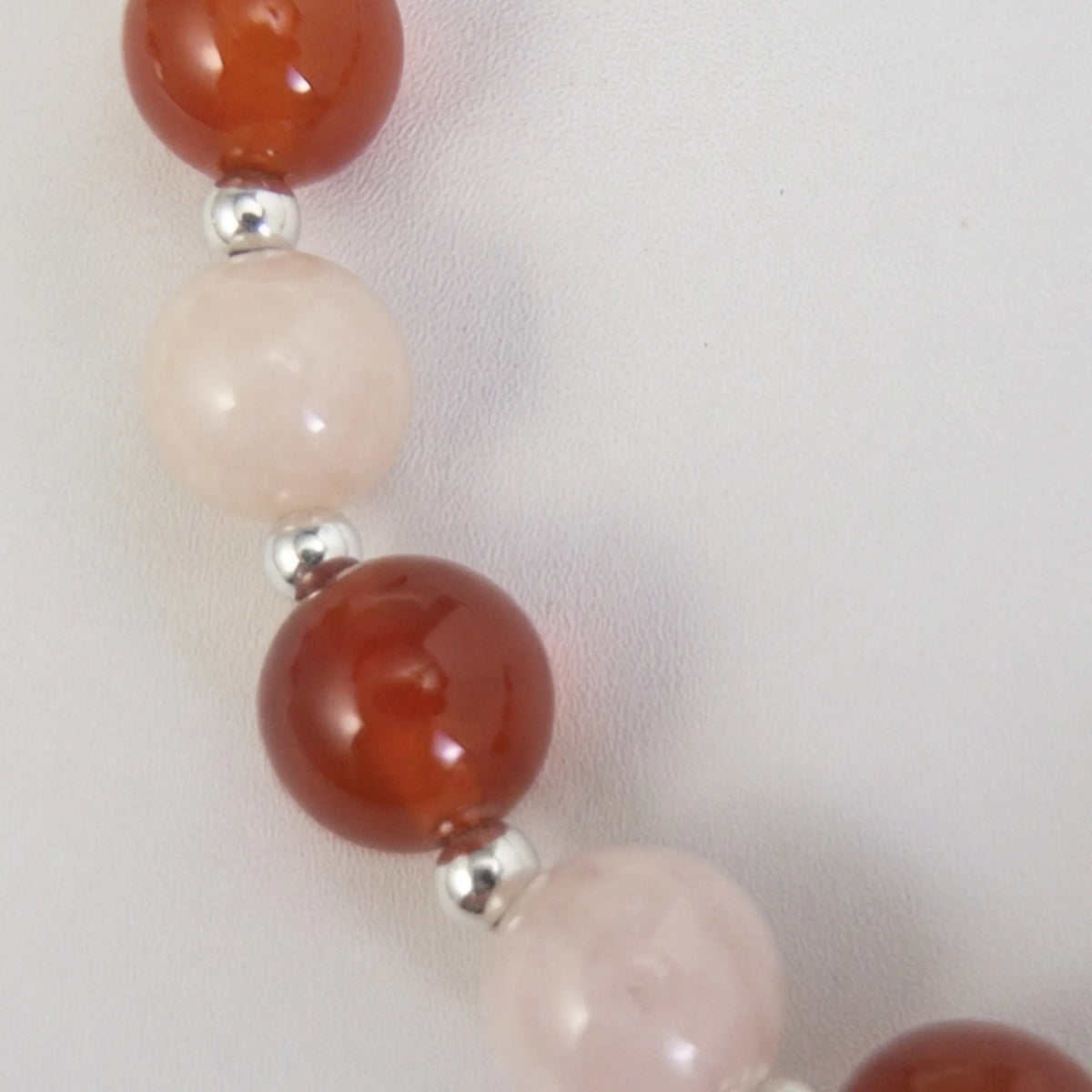 personalised necklace with alternating carnelian and pink morganite beads, silver spacers and bubble initial letter.