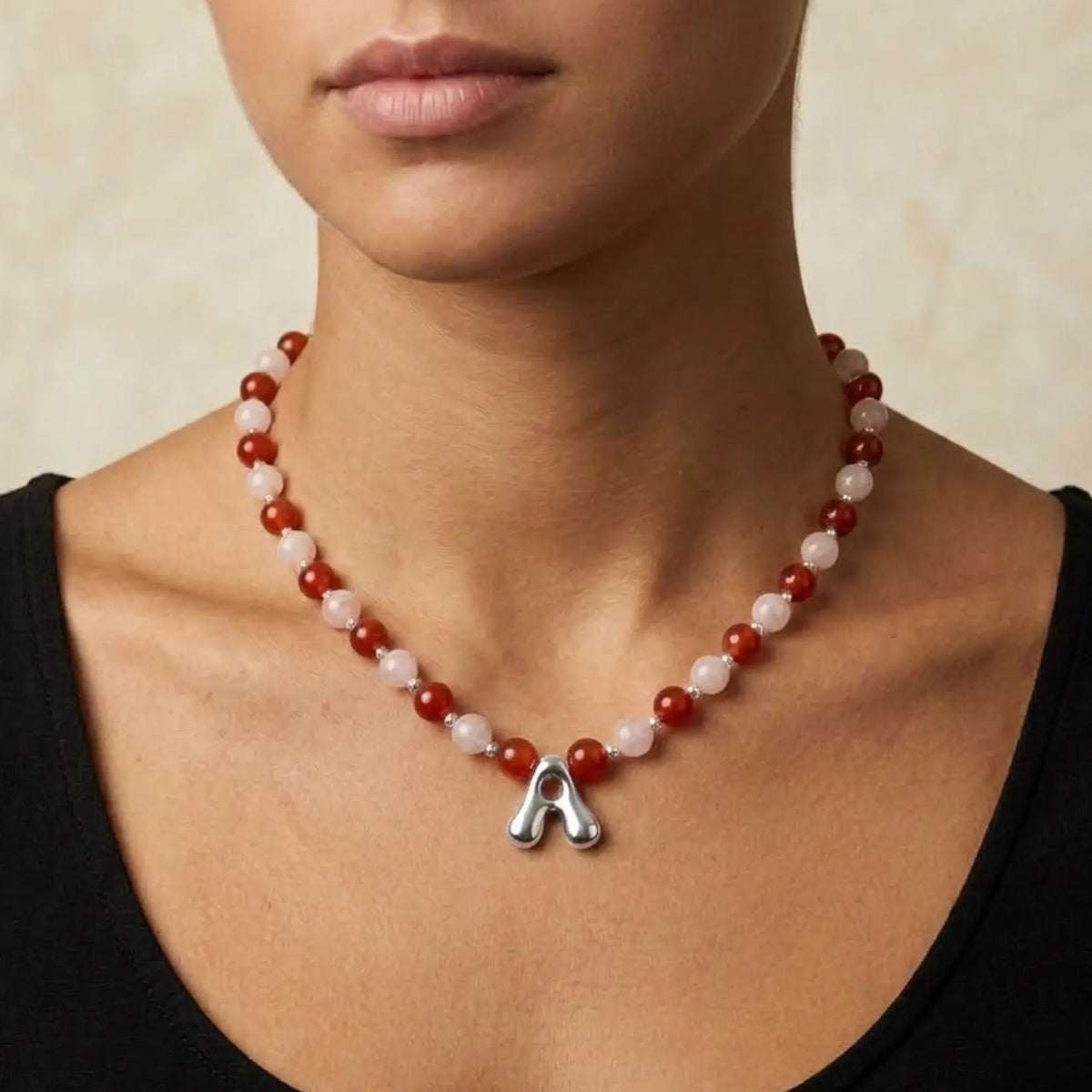 personalised necklace with alternating carnelian and pink morganite beads, silver spacers and bubble initial letter.