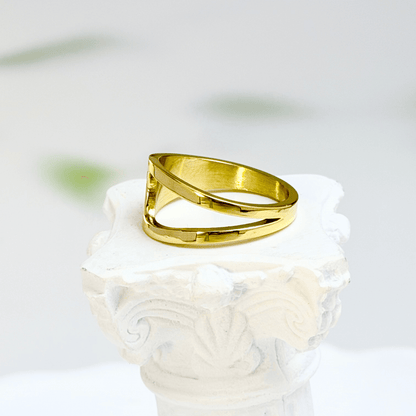 gold carved arc ring on white background, minimal sculptural gold ring