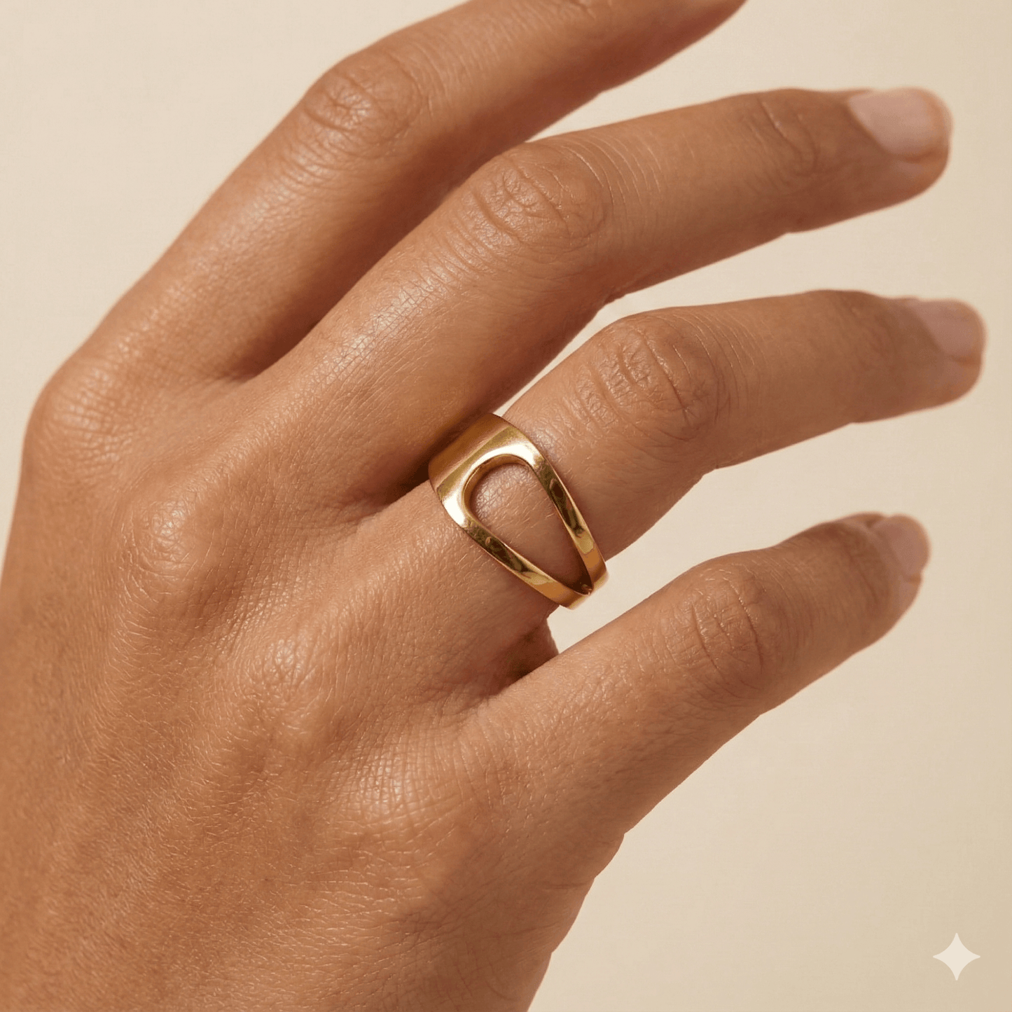 gold carved arc ring on white background, minimal sculptural gold ring
