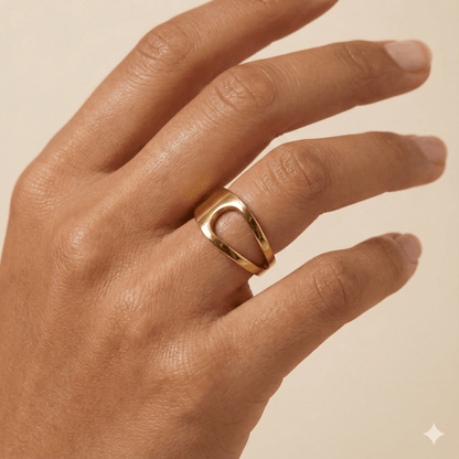 gold carved arc ring on white background, minimal sculptural gold ring
