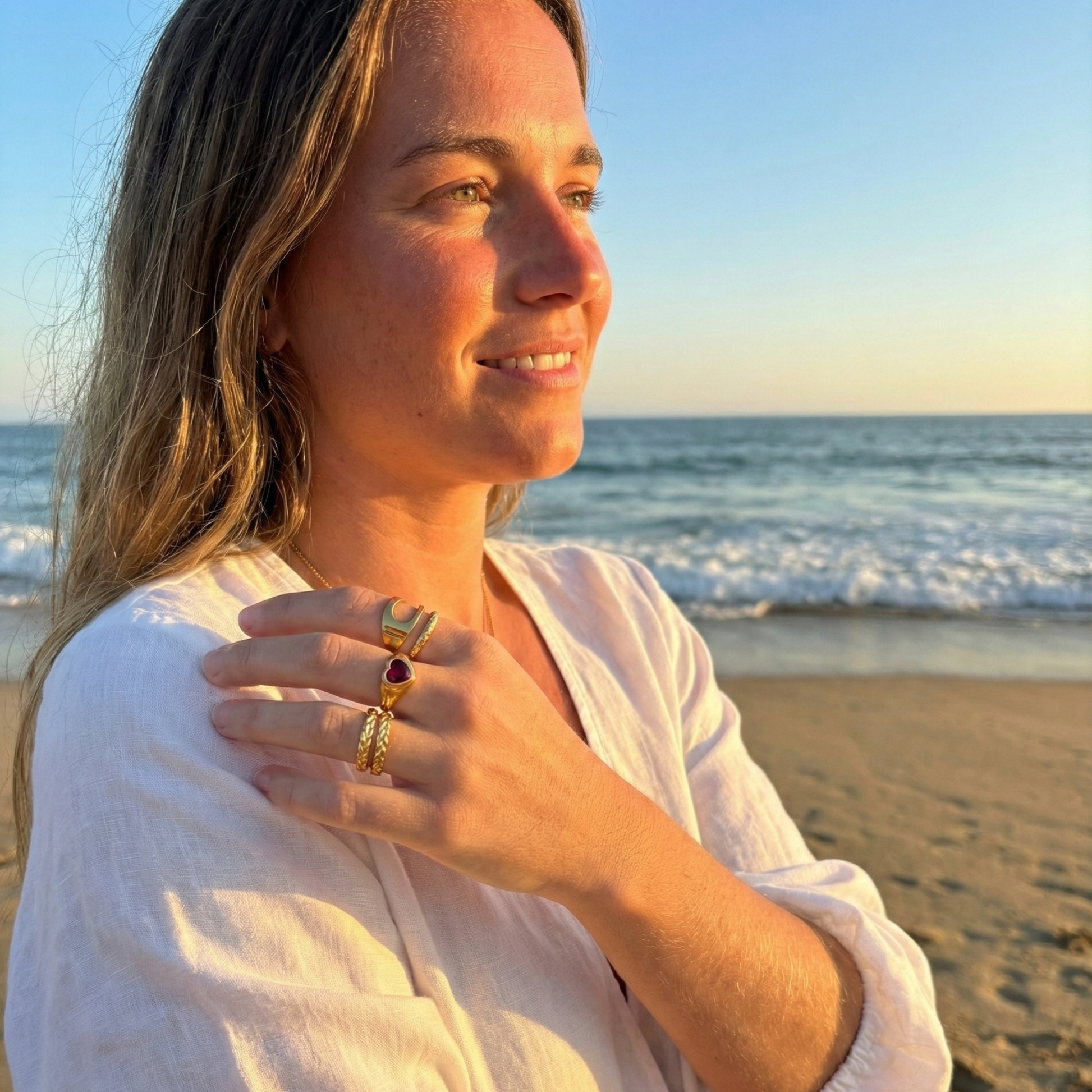 gold carved arc ring on white background, minimal sculptural gold ring