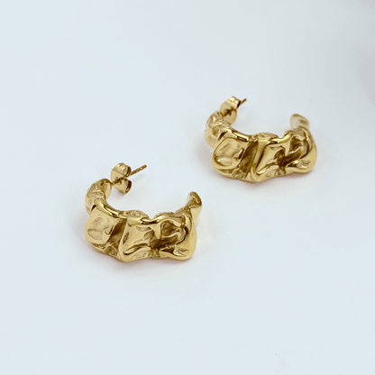 Chunky molten-textured vintage gold hoop earrings with sculpted irregular surface.