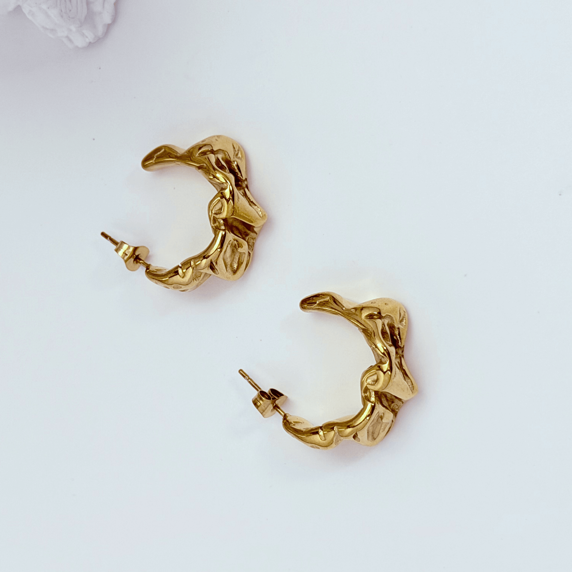 Chunky molten-textured vintage gold hoop earrings with sculpted irregular surface.