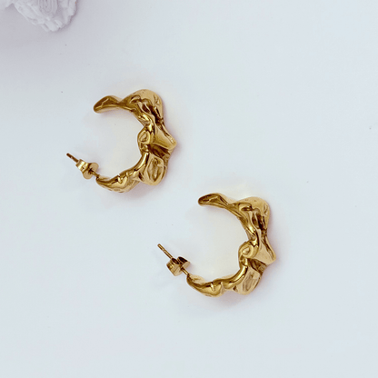 Chunky molten-textured vintage gold hoop earrings with sculpted irregular surface.