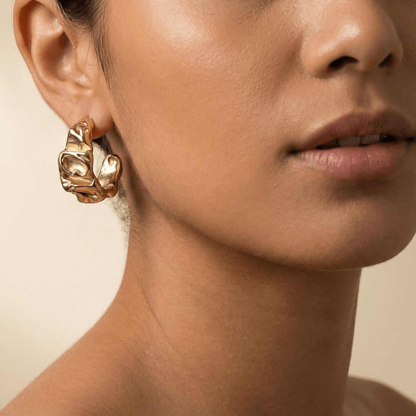 Chunky molten-textured vintage gold hoop earrings with sculpted irregular surface.