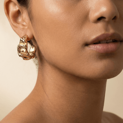 Chunky molten-textured vintage gold hoop earrings with sculpted irregular surface.