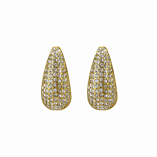 Chunky pavé gold half hoop earrings with crystal detailing, photographed on a clean light background.