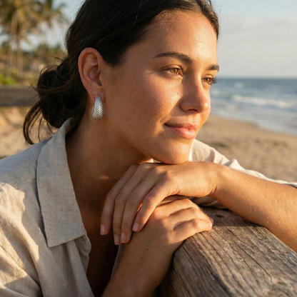 Chunky pavé silver half hoop earrings with crystal detailing, photographed on a light background.