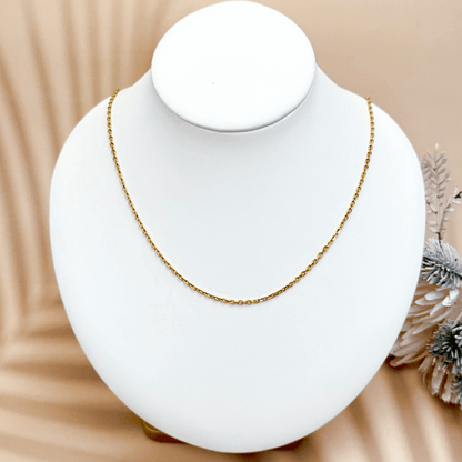 Gold cable chain made of fine interlocking links in a classic minimalist style, available as necklace, bracelet, or anklet