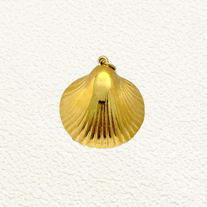 Smooth and polished gold shell charm in a scallop shape, inspired by sea treasures, perfect for beach or summer-themed jewelry.
