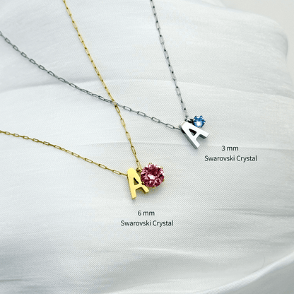 Personalised initial necklace featuring a Swarovski crystal charm on a delicate 1 mm chain, in gold and silver, hypoallergenic and tarnish-resistant.