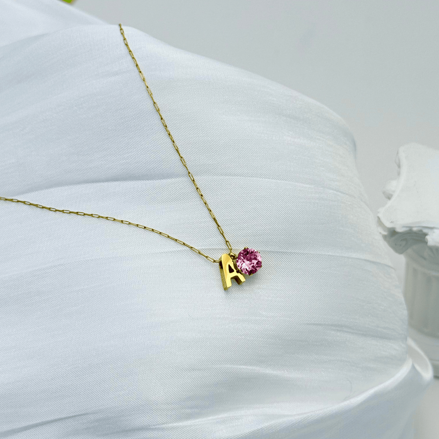 Personalised initial necklace featuring a Swarovski crystal charm on a delicate 1 mm chain, in gold and silver, hypoallergenic and tarnish-resistant.