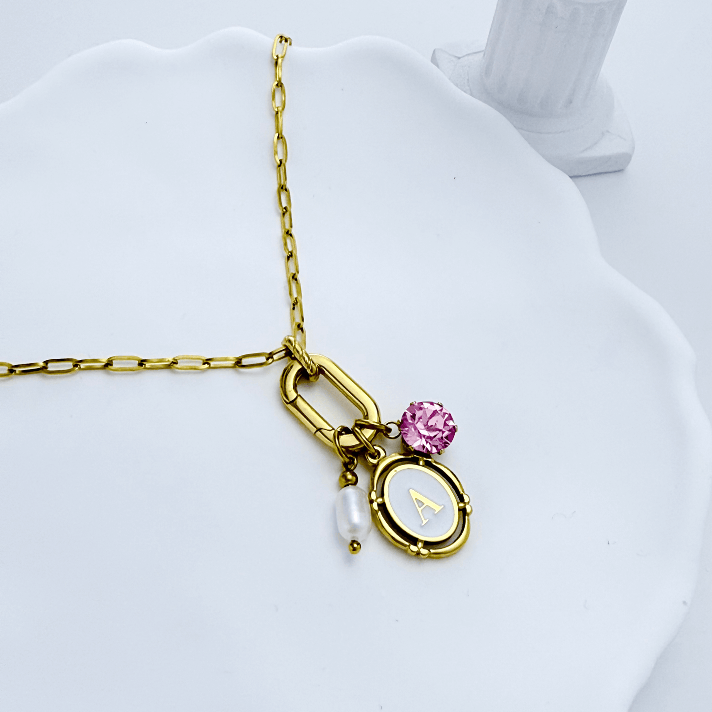 Gold openable link charm necklace with pink Swarovski birthstone and freshwater pearl on waterproof chain, customisable to add any charms