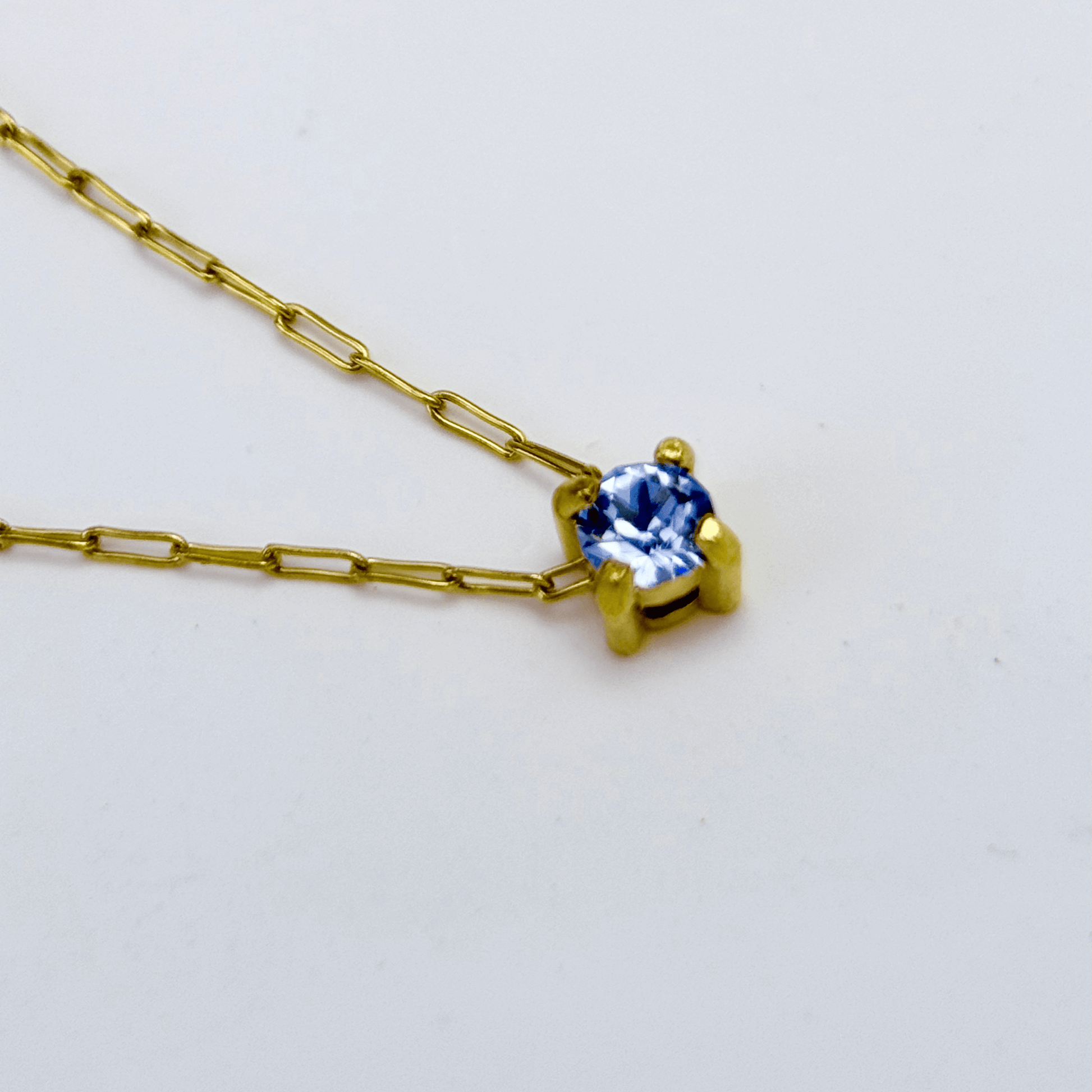 Dainty gold birthstone necklace with sparkling Swarovski element, minimalist and elegant design for everyday wear.