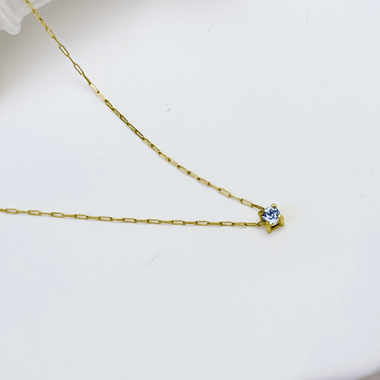Dainty gold birthstone necklace with sparkling Swarovski element, minimalist and elegant design for everyday wear.