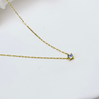 Dainty gold birthstone necklace with sparkling Swarovski element, minimalist and elegant design for everyday wear.