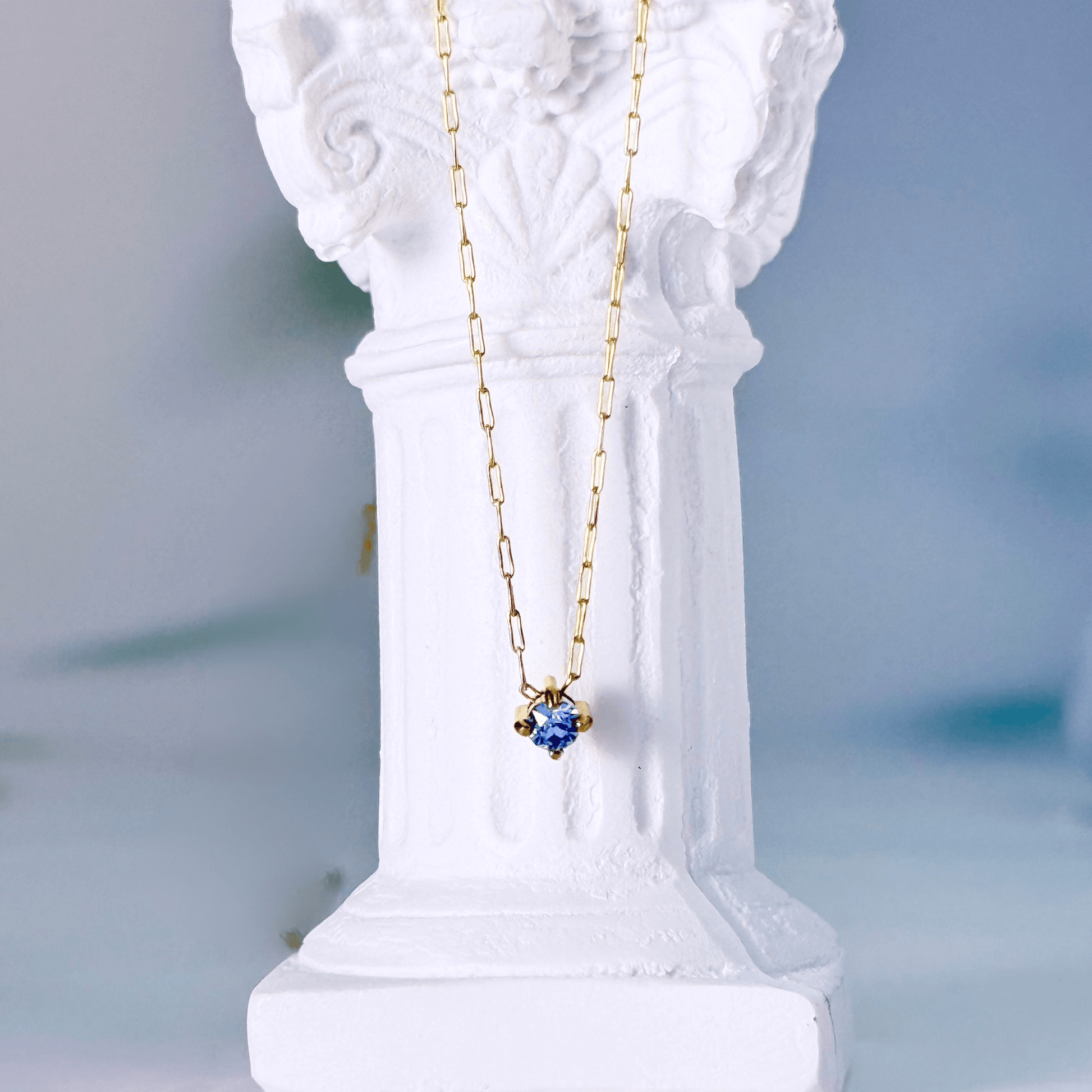 Dainty gold birthstone necklace with sparkling Swarovski element, minimalist and elegant design for everyday wear.