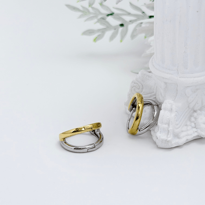 Dual-tone gold and silver huggie earrings with polished modern design