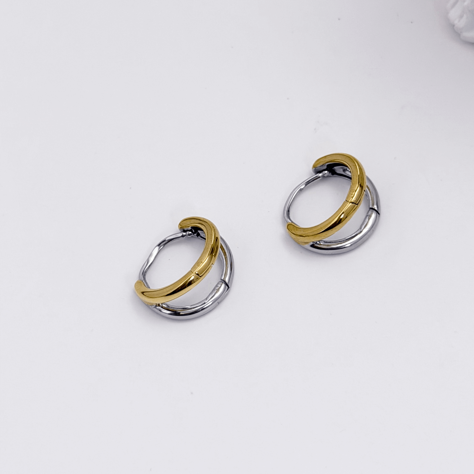 Dual-tone gold and silver huggie earrings with polished modern design