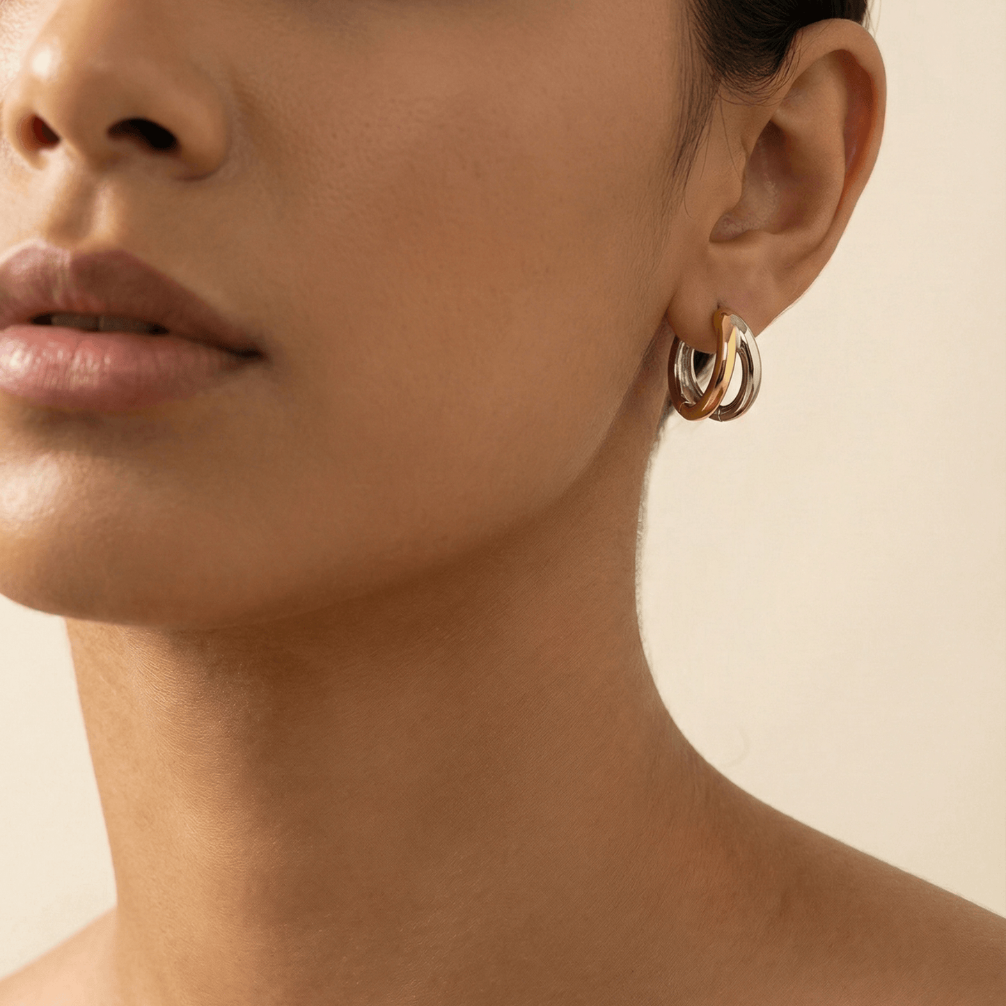 Dual-tone gold and silver huggie earrings with polished modern design