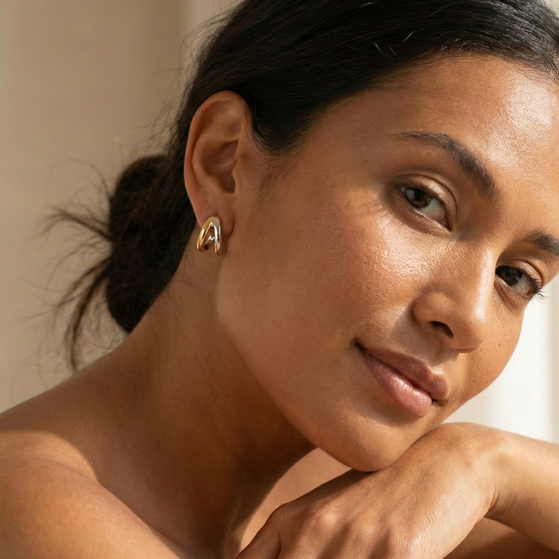 Dual-tone gold and silver huggie earrings with polished modern design