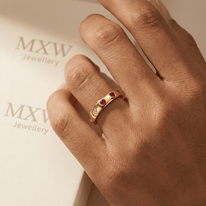 Gold waterproof ring with alternating pink and clear heart-shaped stones.