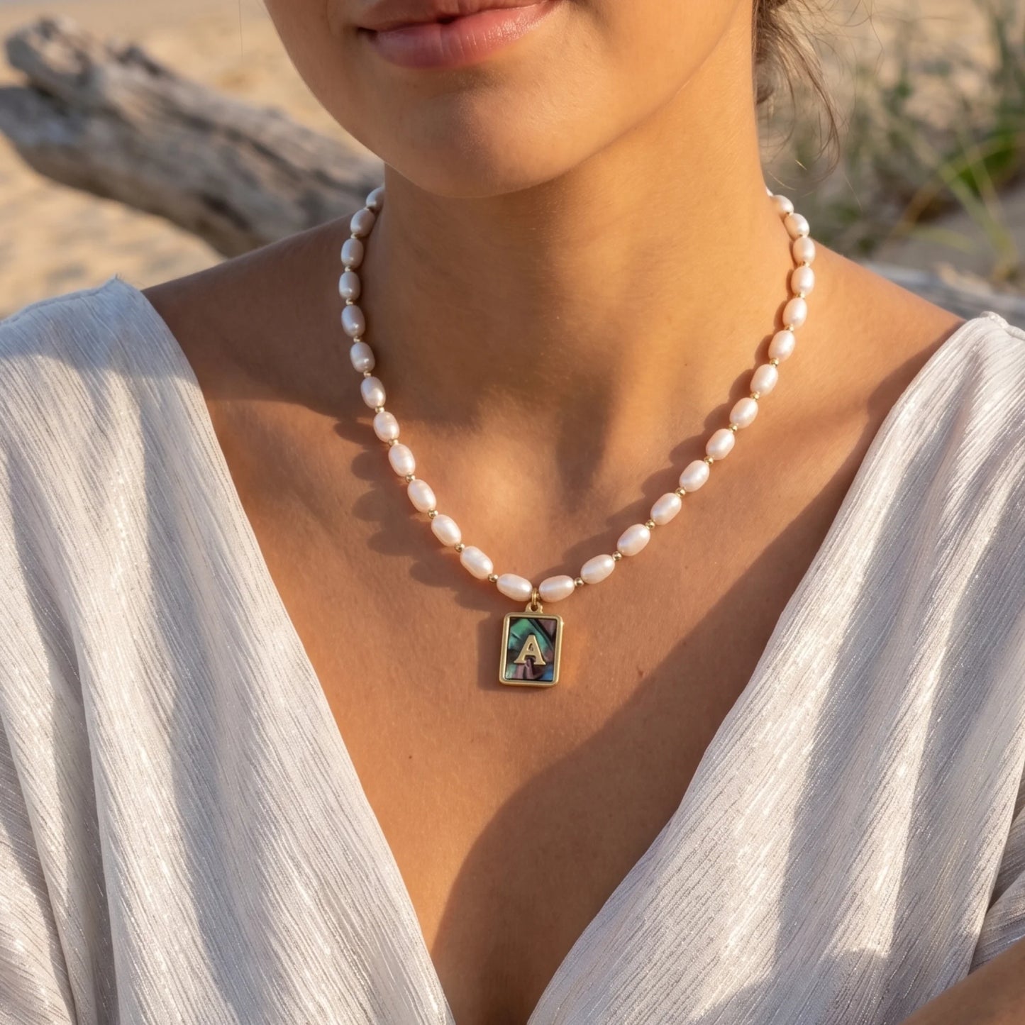 Premium freshwater rice pearl and 14K gold filled beaded necklace with personalised abalone shell initial charm, hand-finished in Australia