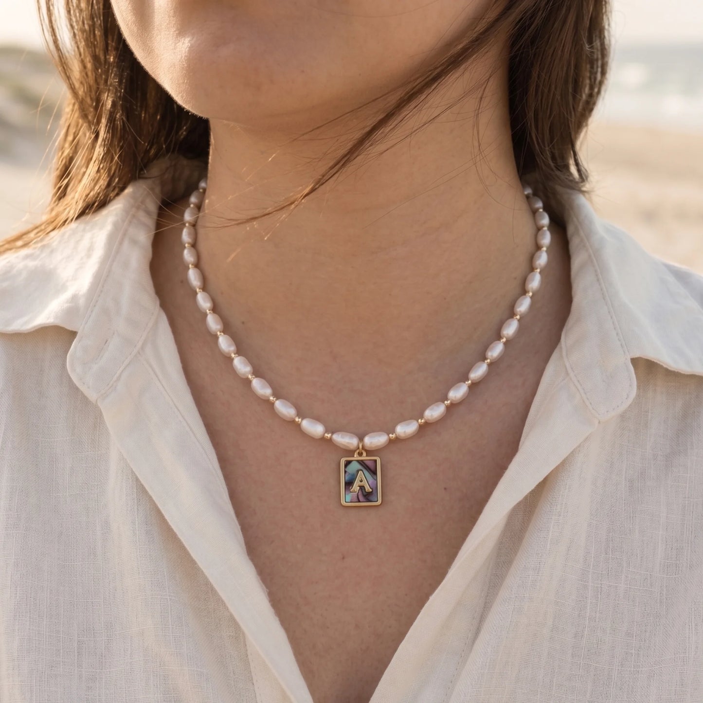 Premium freshwater rice pearl and 14K gold filled beaded necklace with personalised abalone shell initial charm, hand-finished in Australia