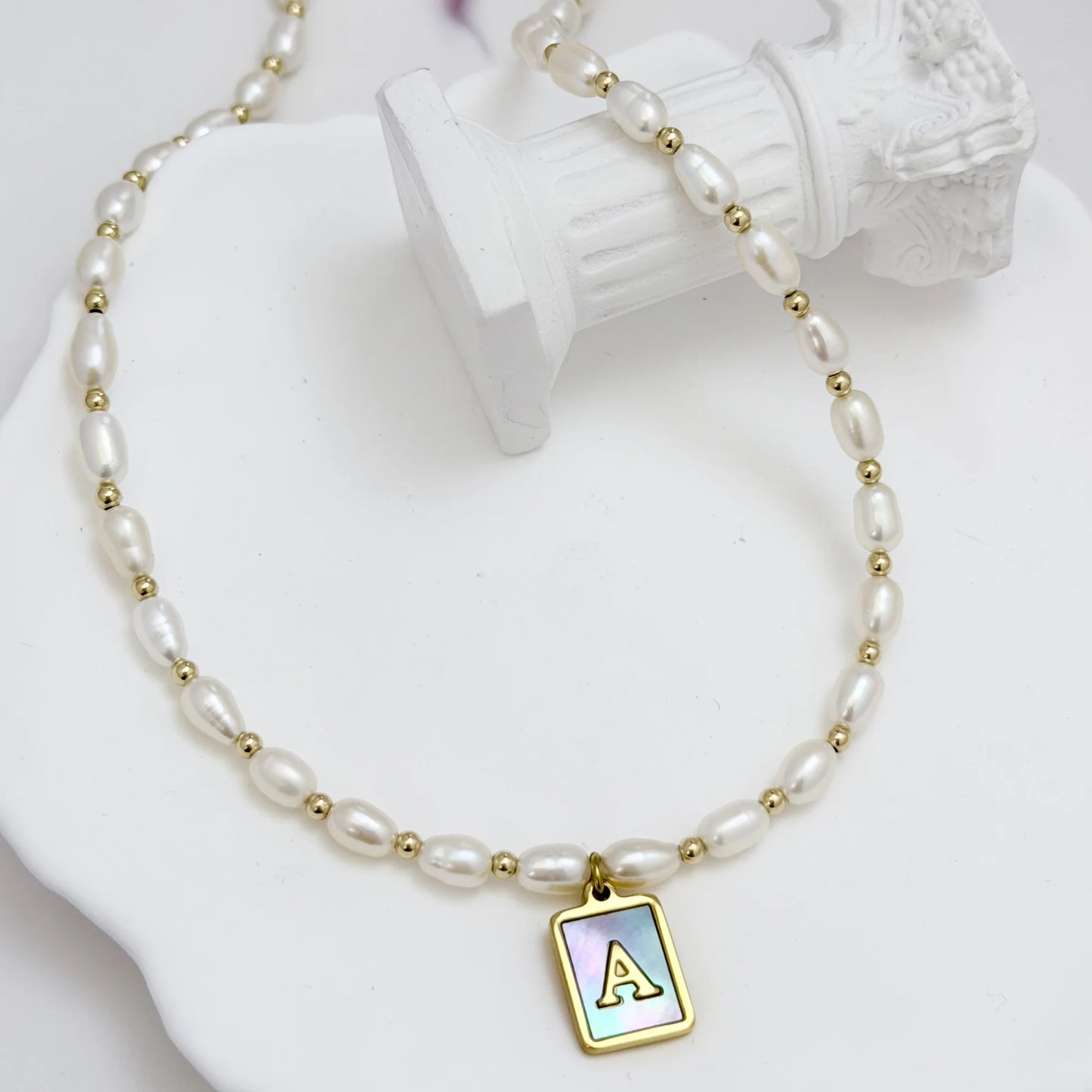 Premium freshwater rice pearl and 14K gold filled beaded necklace with personalised blue mother of shell initial charm, hand-finished in Australia