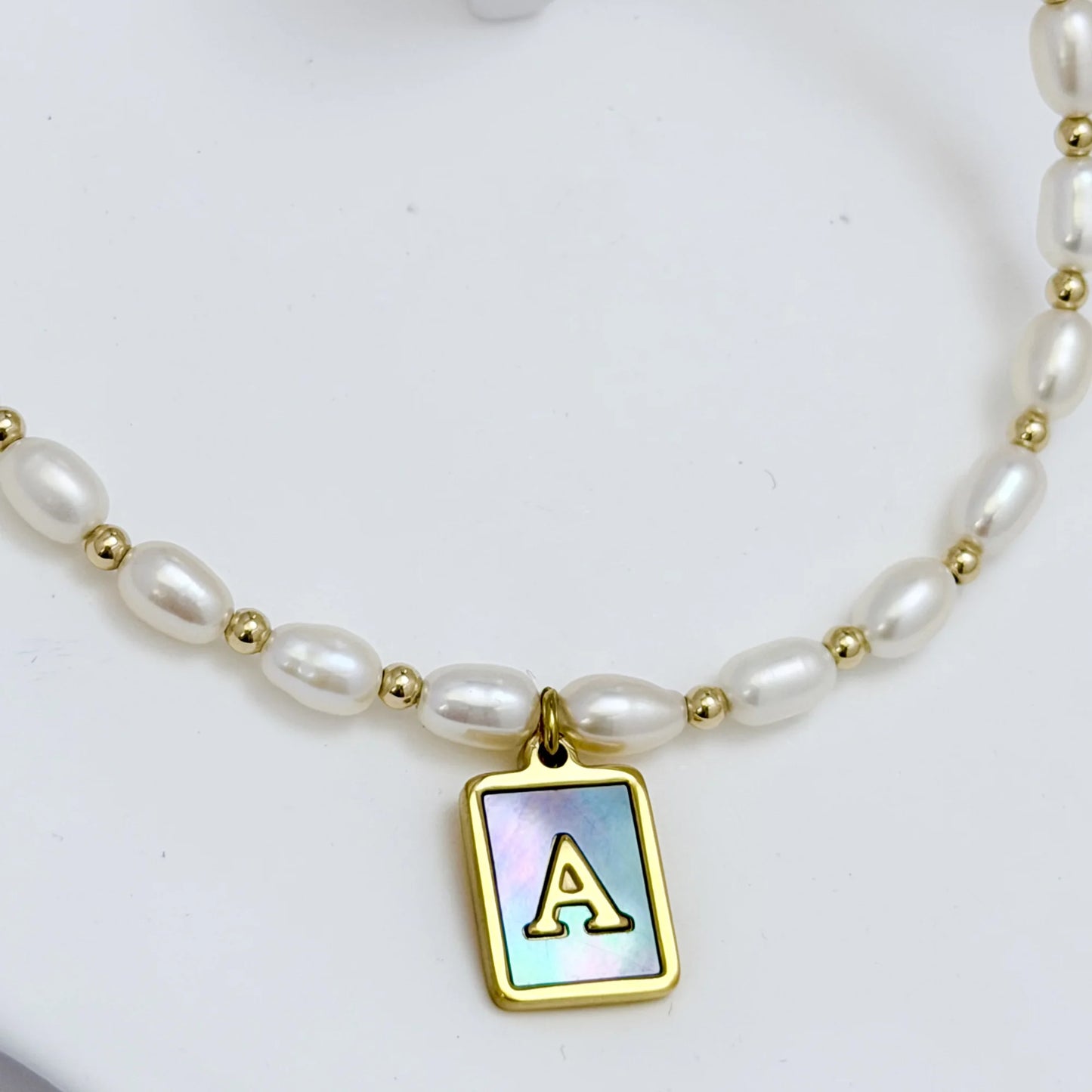 Premium freshwater rice pearl and 14K gold filled beaded necklace with personalised blue mother of shell initial charm, hand-finished in Australia
