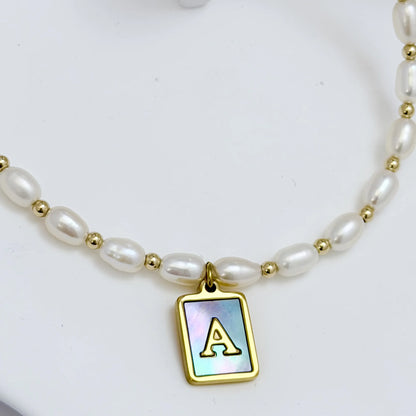 Premium freshwater rice pearl and 14K gold filled beaded necklace with personalised blue mother of shell initial charm, hand-finished in Australia