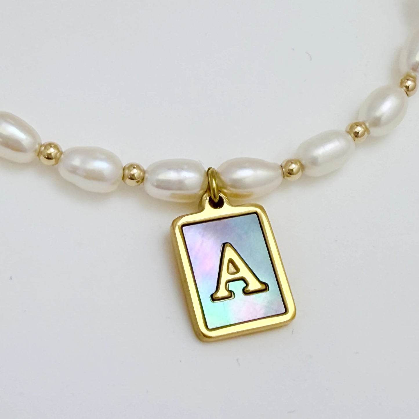 Premium freshwater rice pearl and 14K gold filled beaded necklace with personalised blue mother of shell initial charm, hand-finished in Australia