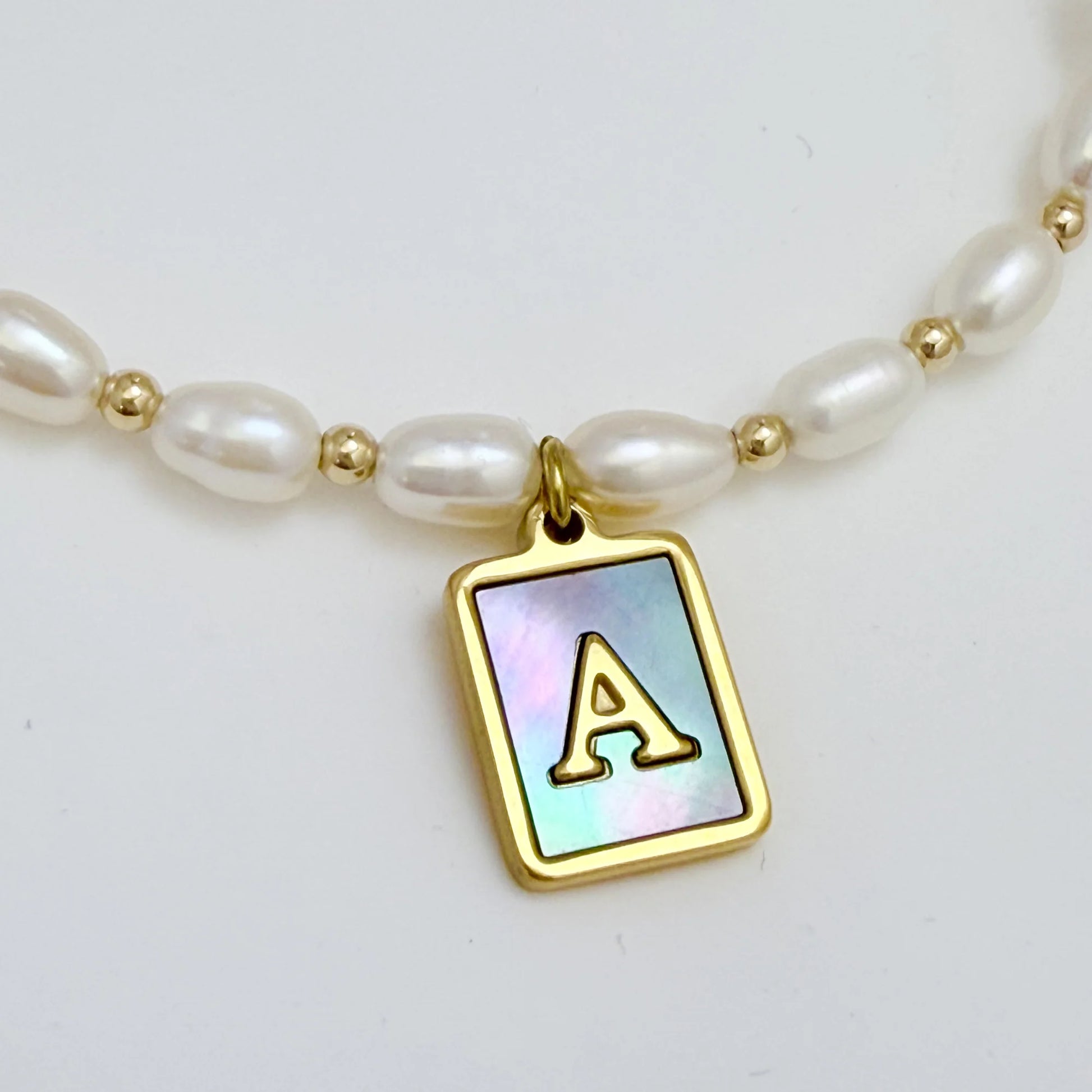Premium freshwater rice pearl and 14K gold filled beaded necklace with personalised blue mother of shell initial charm, hand-finished in Australia