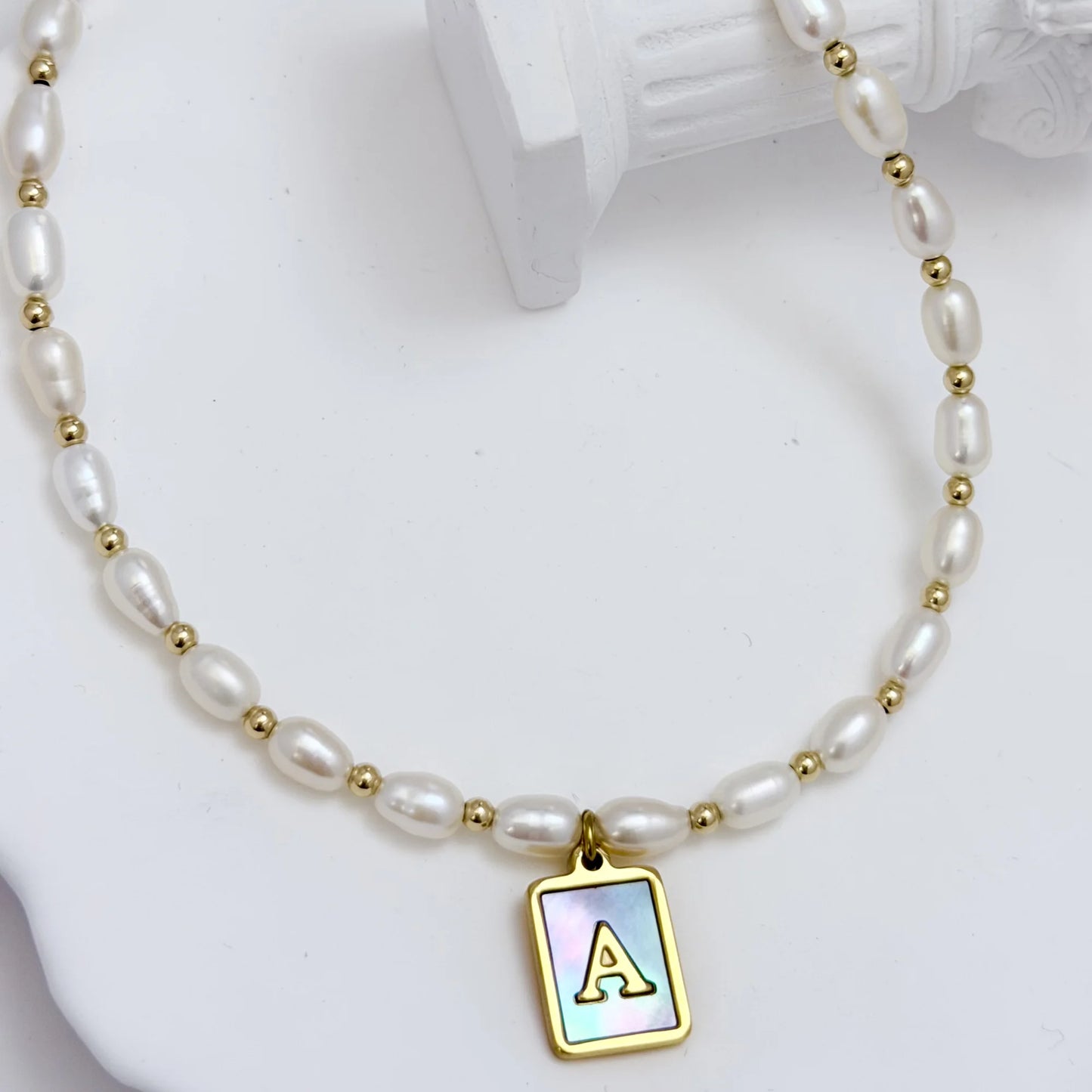 Premium freshwater rice pearl and 14K gold filled beaded necklace with personalised blue mother of shell initial charm, hand-finished in Australia