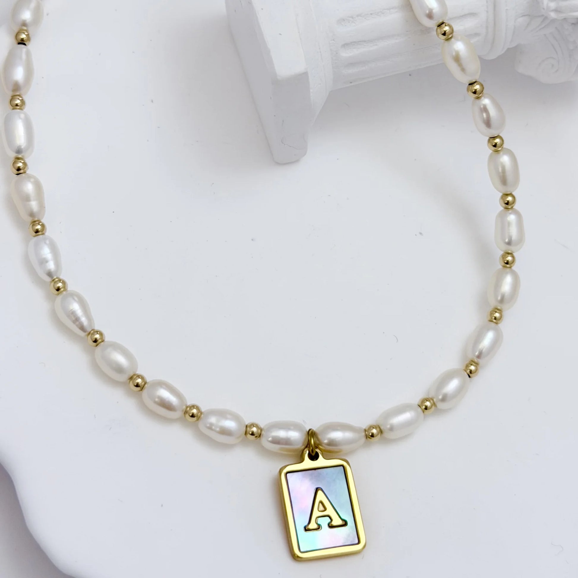 Premium freshwater rice pearl and 14K gold filled beaded necklace with personalised blue mother of shell initial charm, hand-finished in Australia